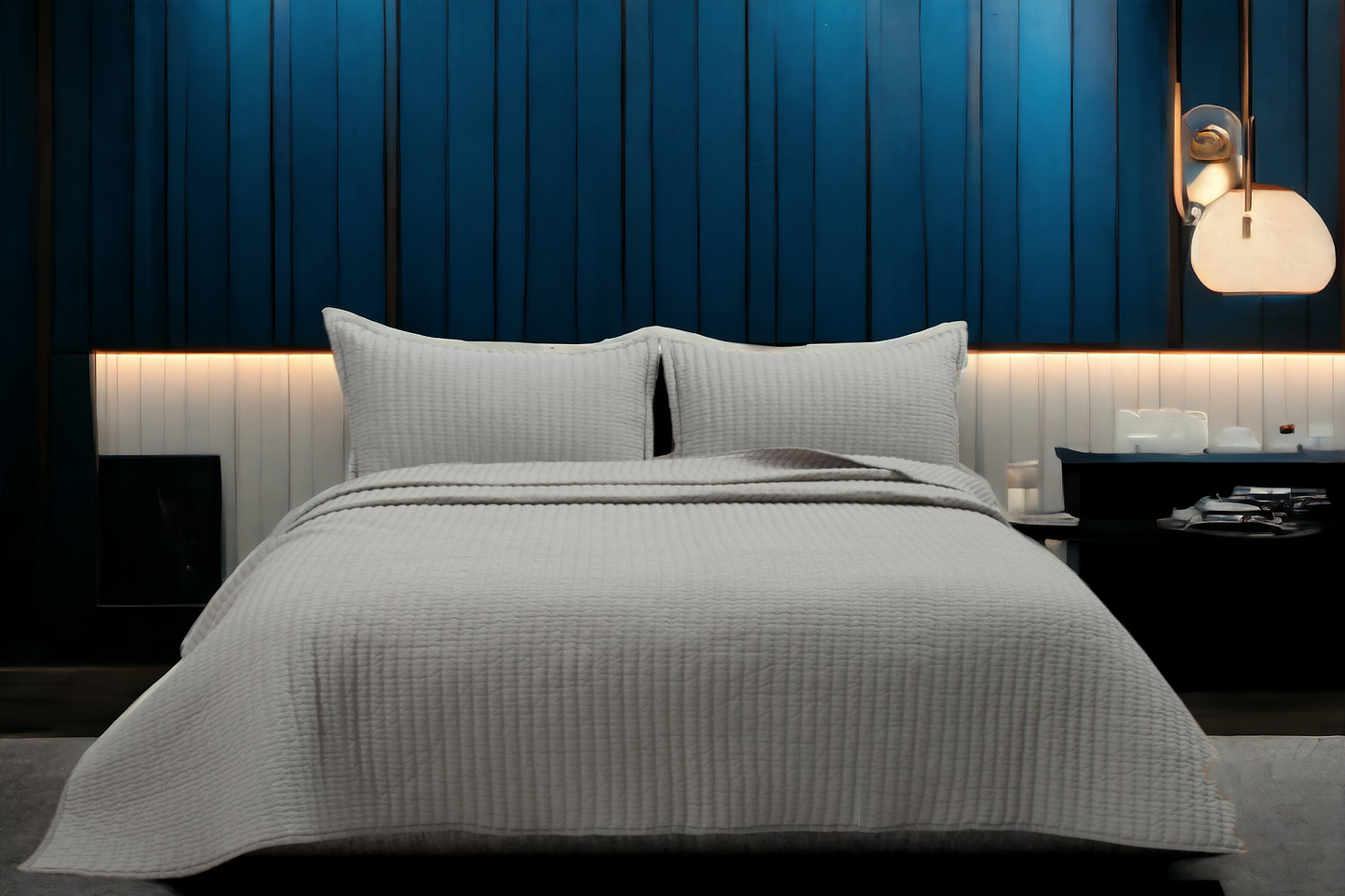 A bedcover set, spread on a bed