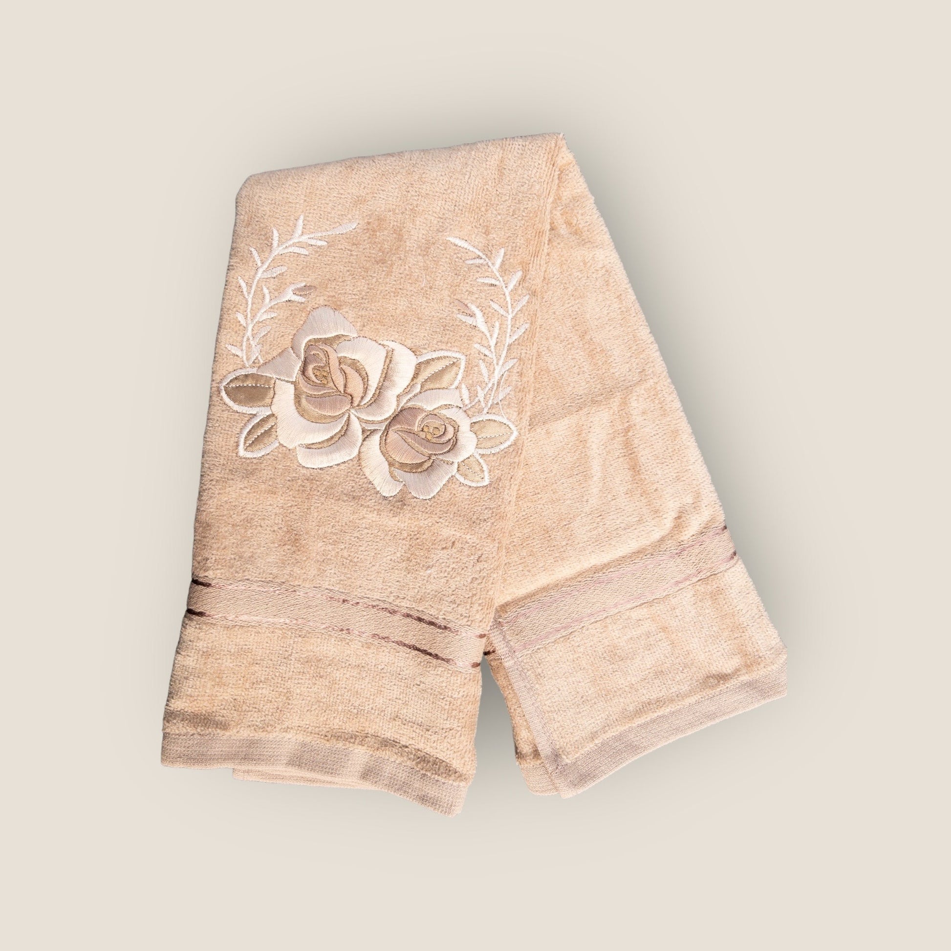 beige hand towel with floral embroidery