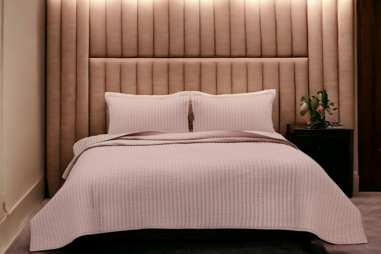 A bedcover set, spread on a bed
