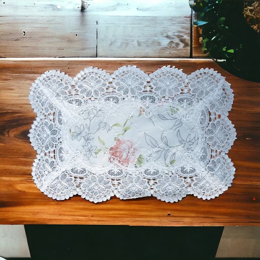 White lace table mat with floral print placed on a dining table
