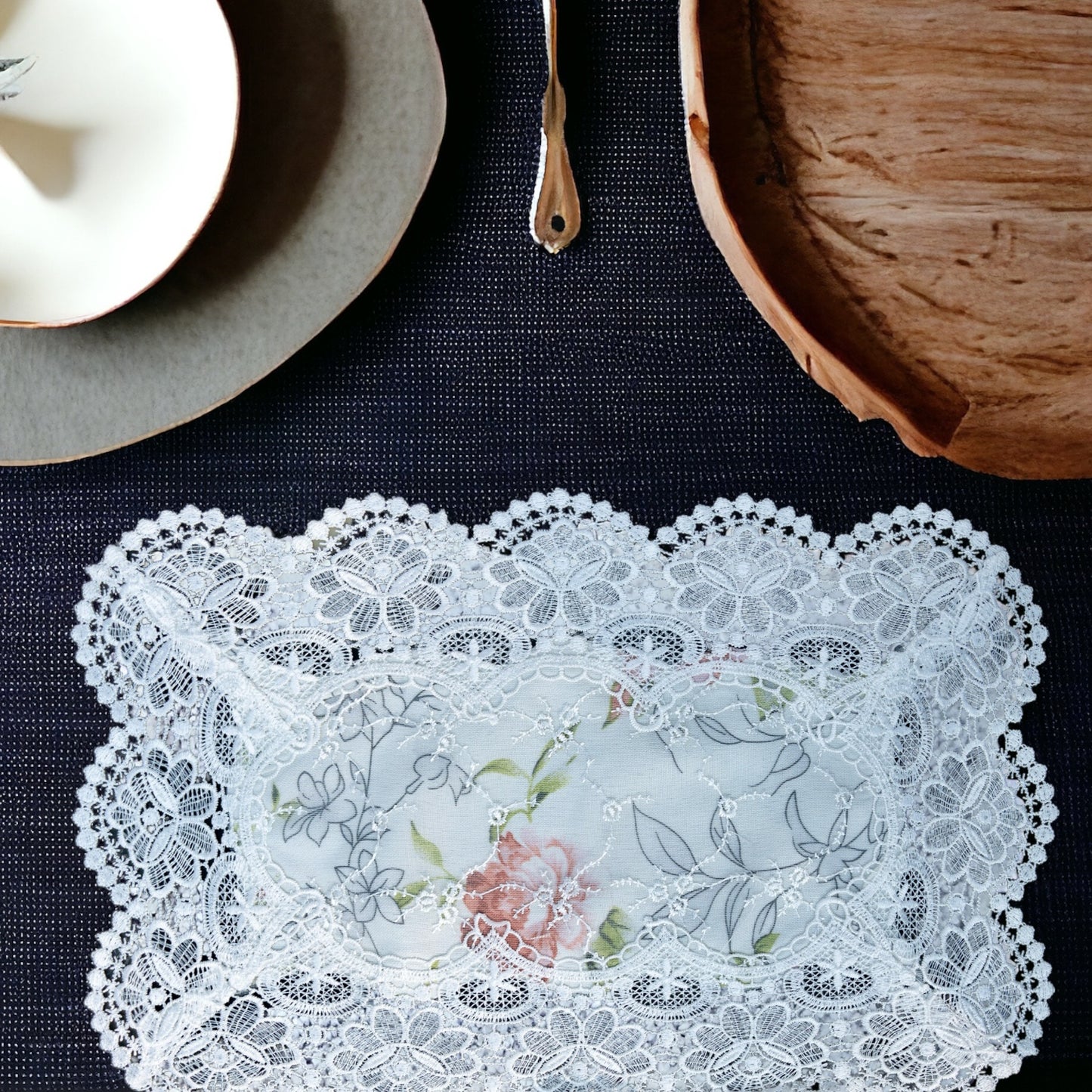 White lace table mat with floral print placed on a dining table