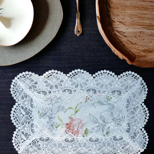 White lace table mat with floral print placed on a dining table