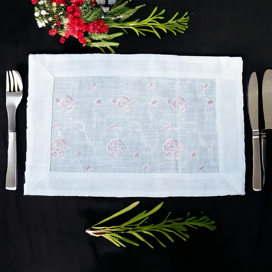 White linen table mat with floral print placed on a dining table