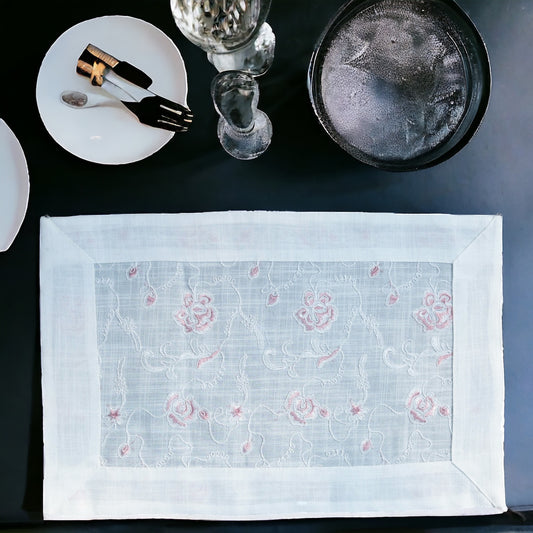White  linen table mat with floral print placed on a dining table