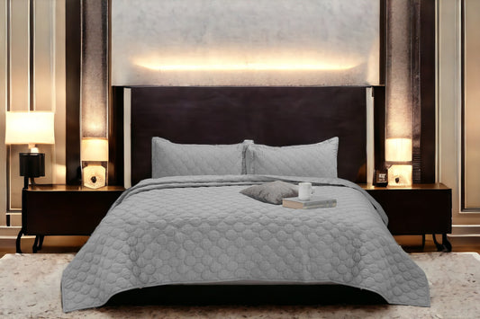 Close up of a bedcover set, spread on a bed
