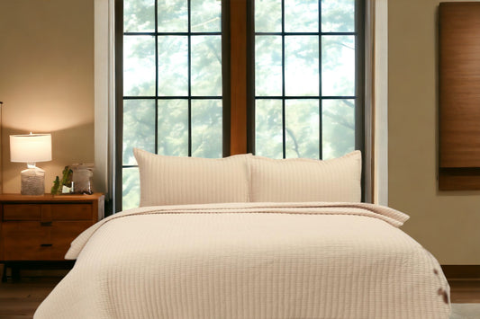 A bedcover set, spread on a bed