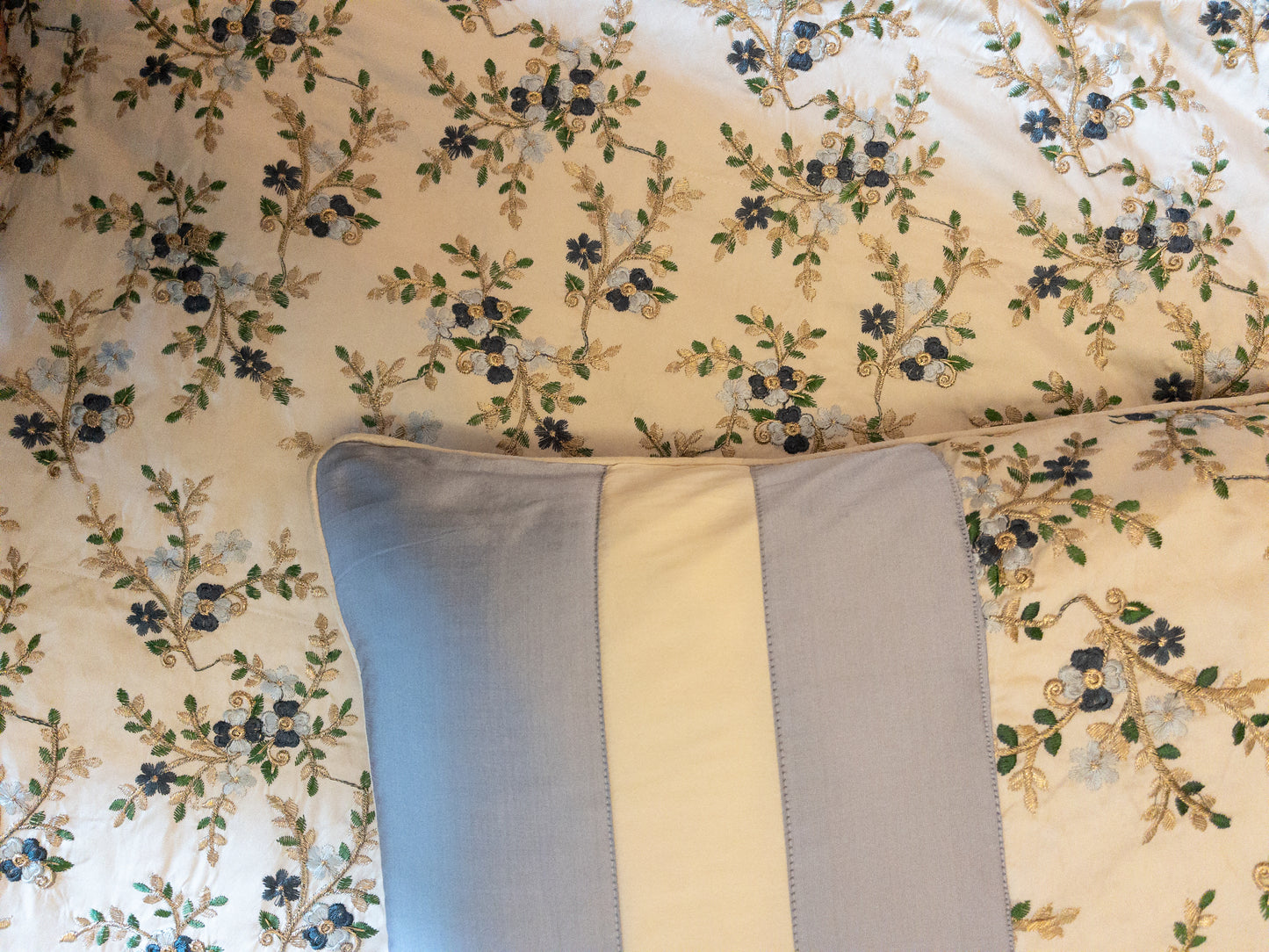 A bedcover set, spread on a bed