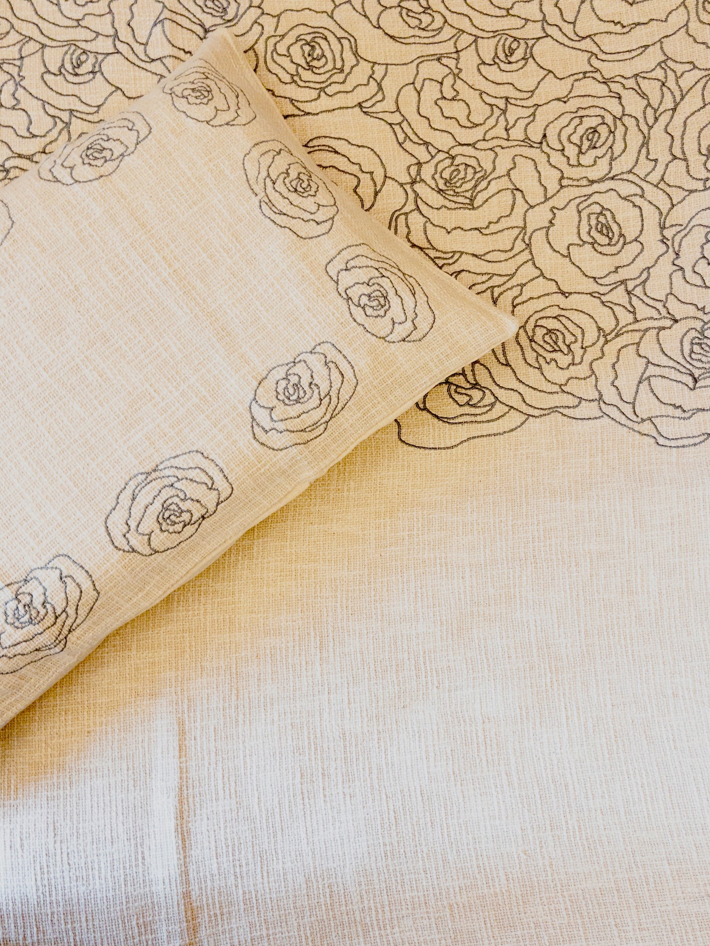 A bedcover set, spread on a bed