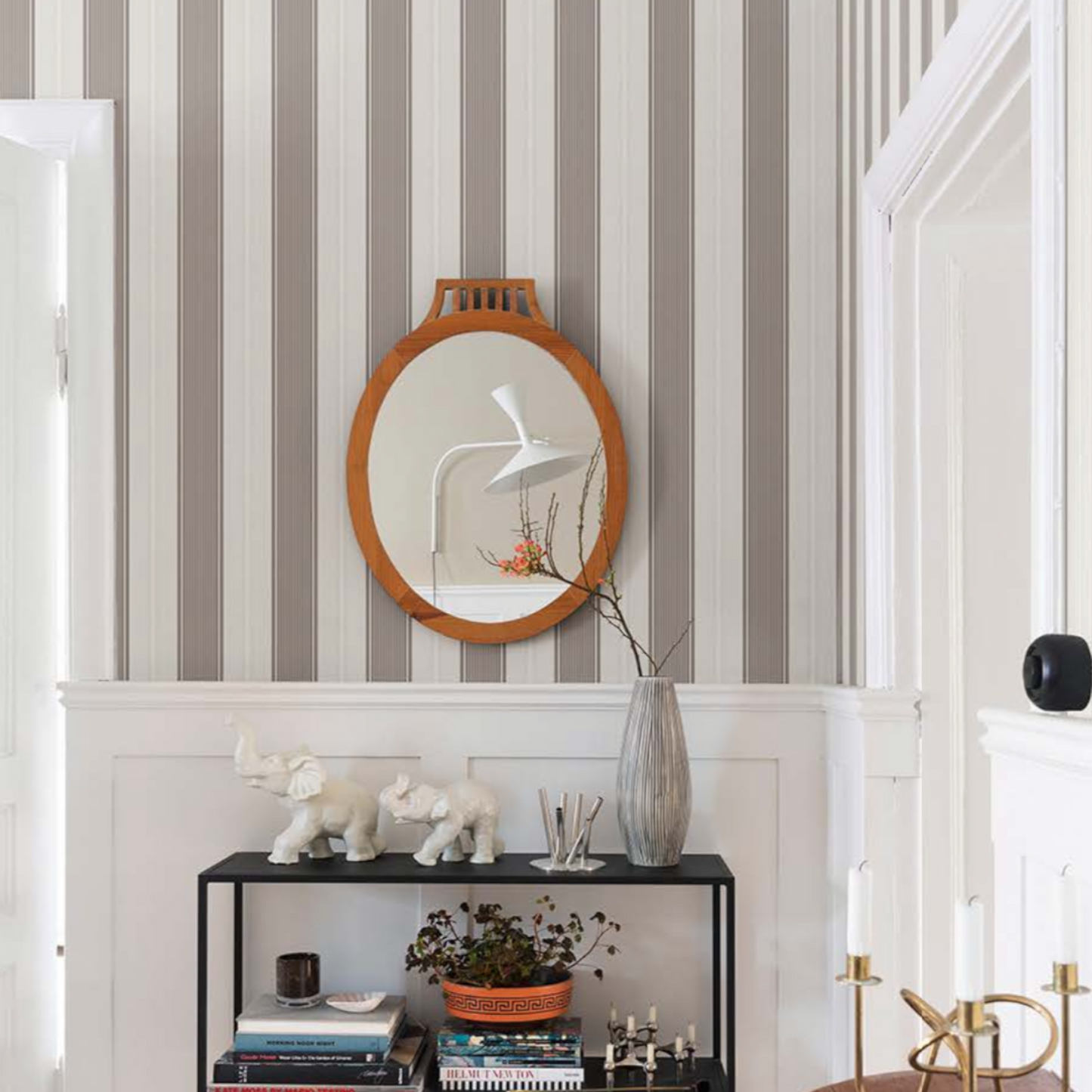 a wall adorned with a grey and white striped wallpaper