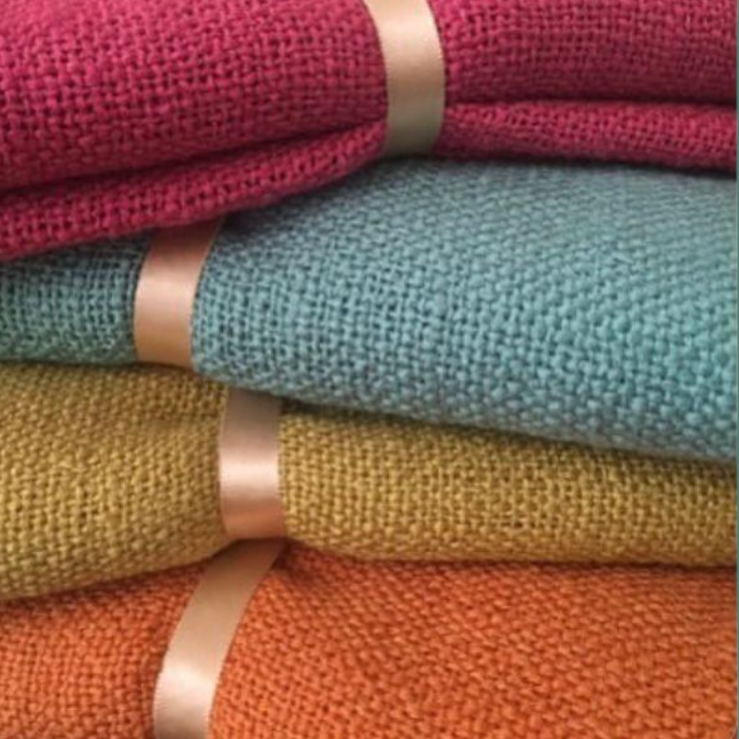 stack of brightly colored knitted throws