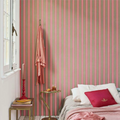 bedroom adorned with pink and grey striped wallpaper