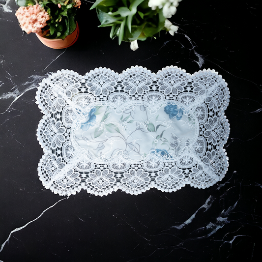 White lace table mat with floral print placed on a dining table