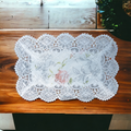 White lace table mat with floral print placed on a dining table