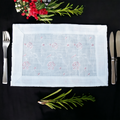 White linen table mat with floral print placed on a dining table
