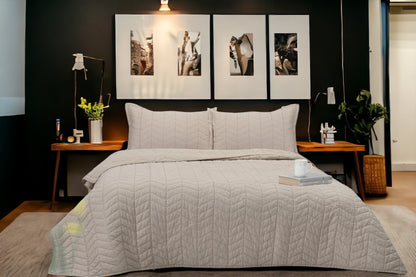 A bedcover set, spread on a bed