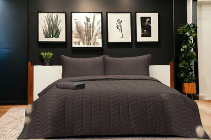 A bedcover set, spread on a bed