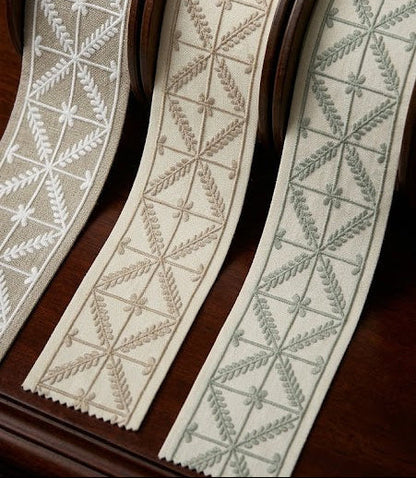 Criss cross embroidered trim collection in ivory, beige and sage styled together