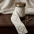 Ivory and beige criss cross embroidered trim swatch by Venia Home