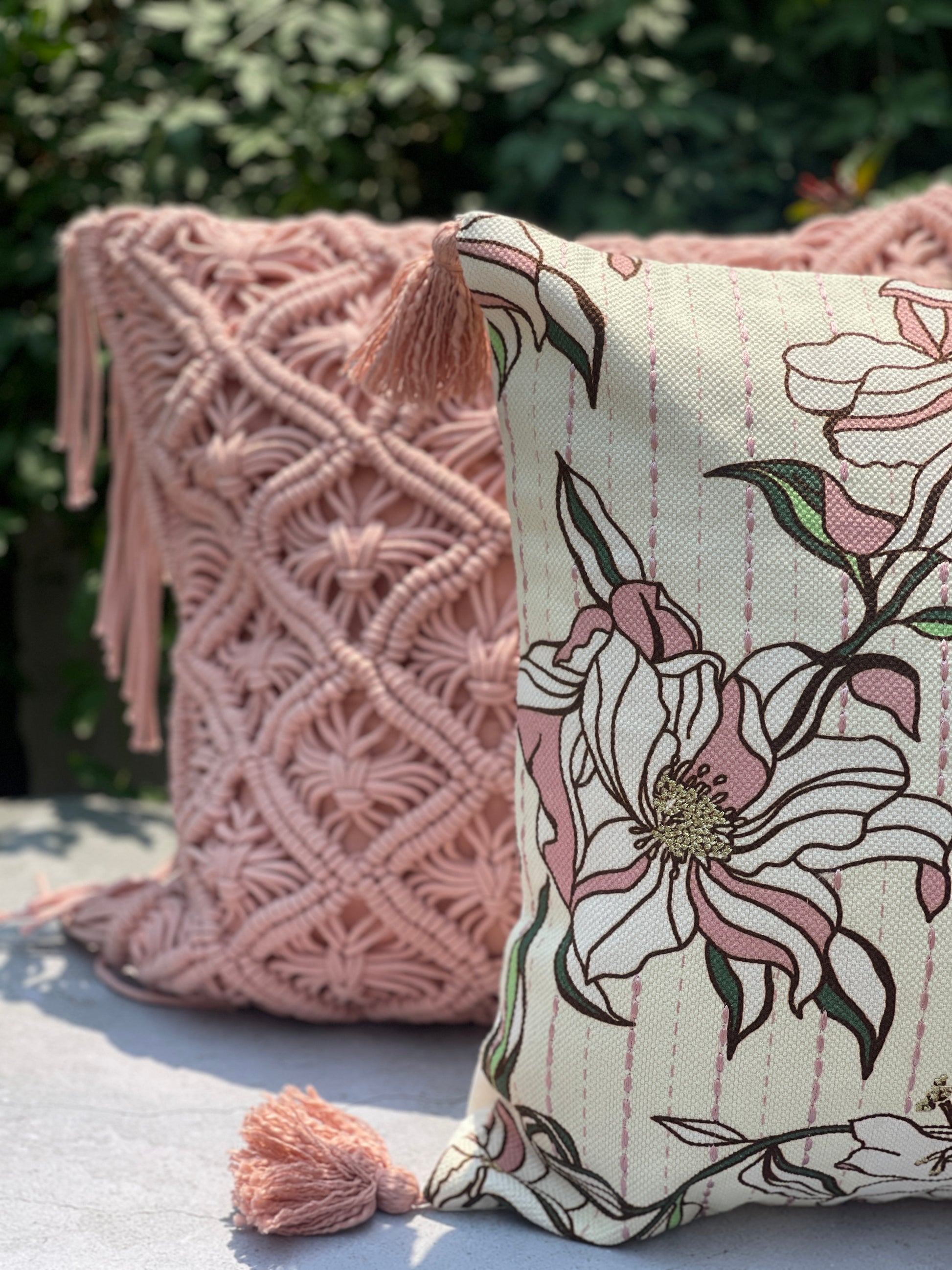 beautiful pink and white cushion covers, one with floral  patterns and other with macarame work