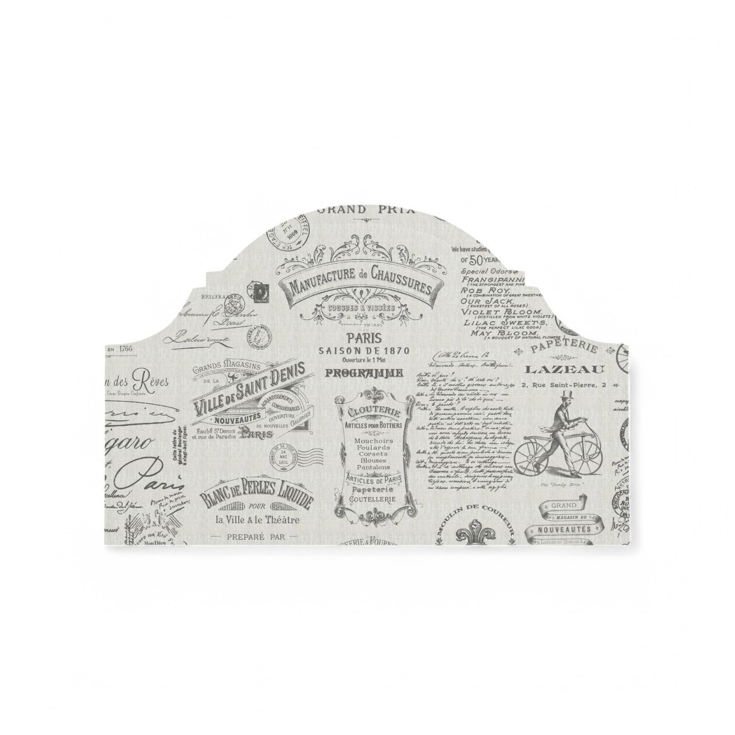 Charcoal Parisian script fabric on a headboard