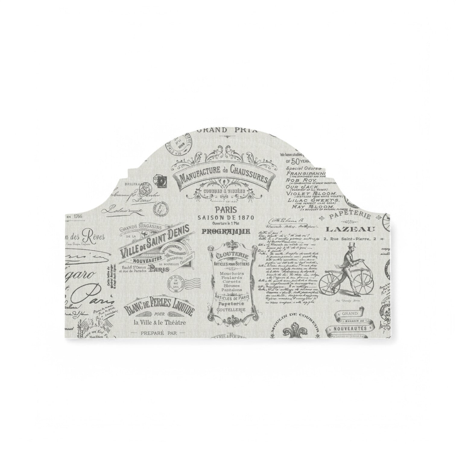 Charcoal Parisian script fabric on a headboard