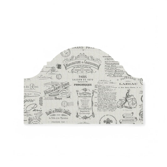 Charcoal Parisian script fabric on a headboard