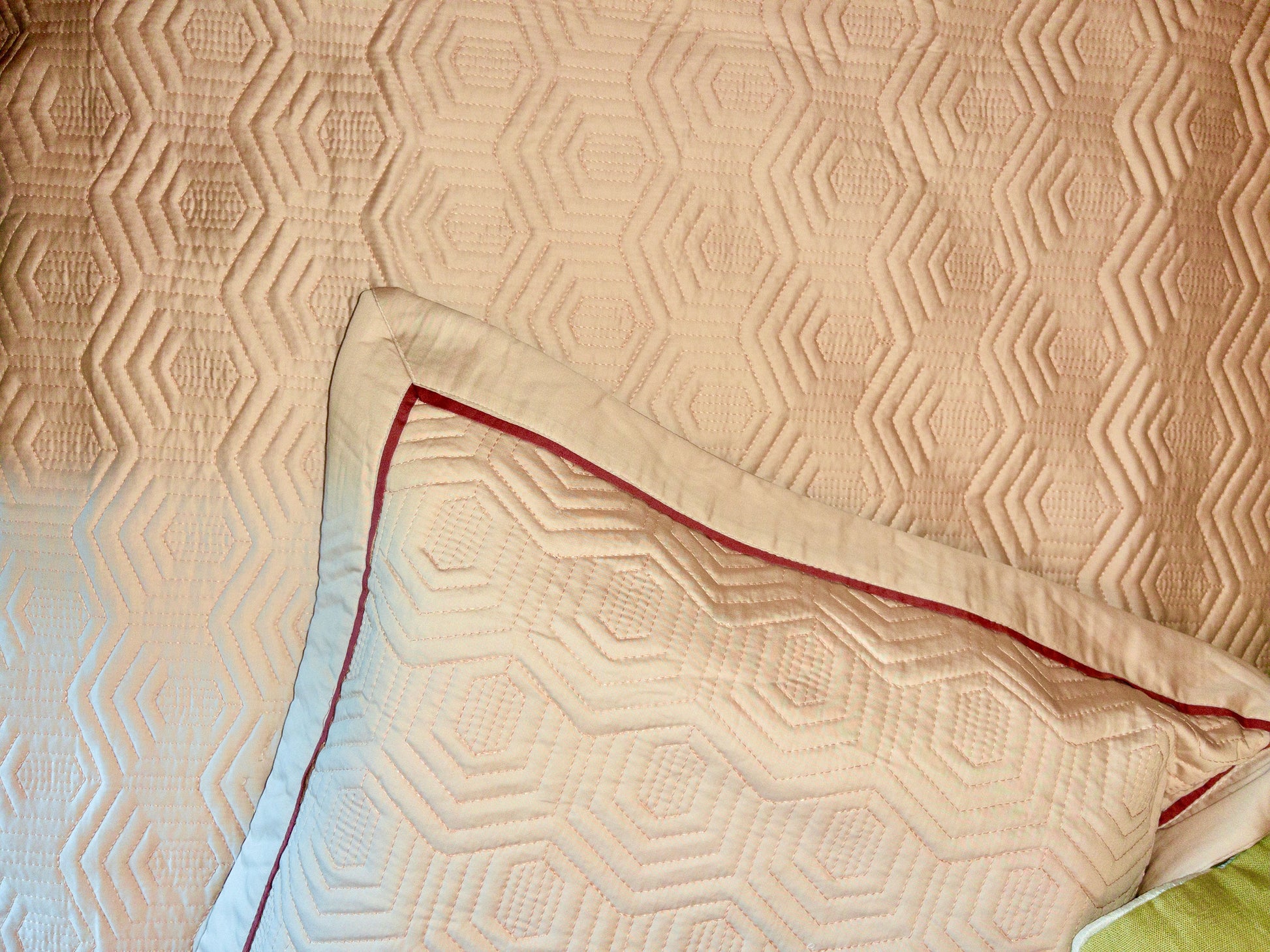 A bedcover set, spread on a bed