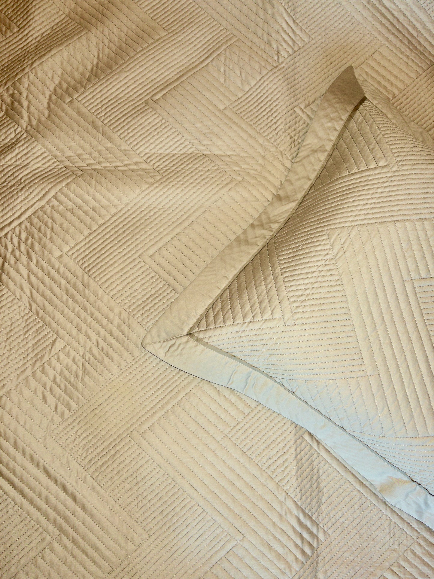 A bedcover set, spread on a bed