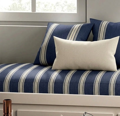 Navy and white striped sofa with decorative pillows in a living room setting