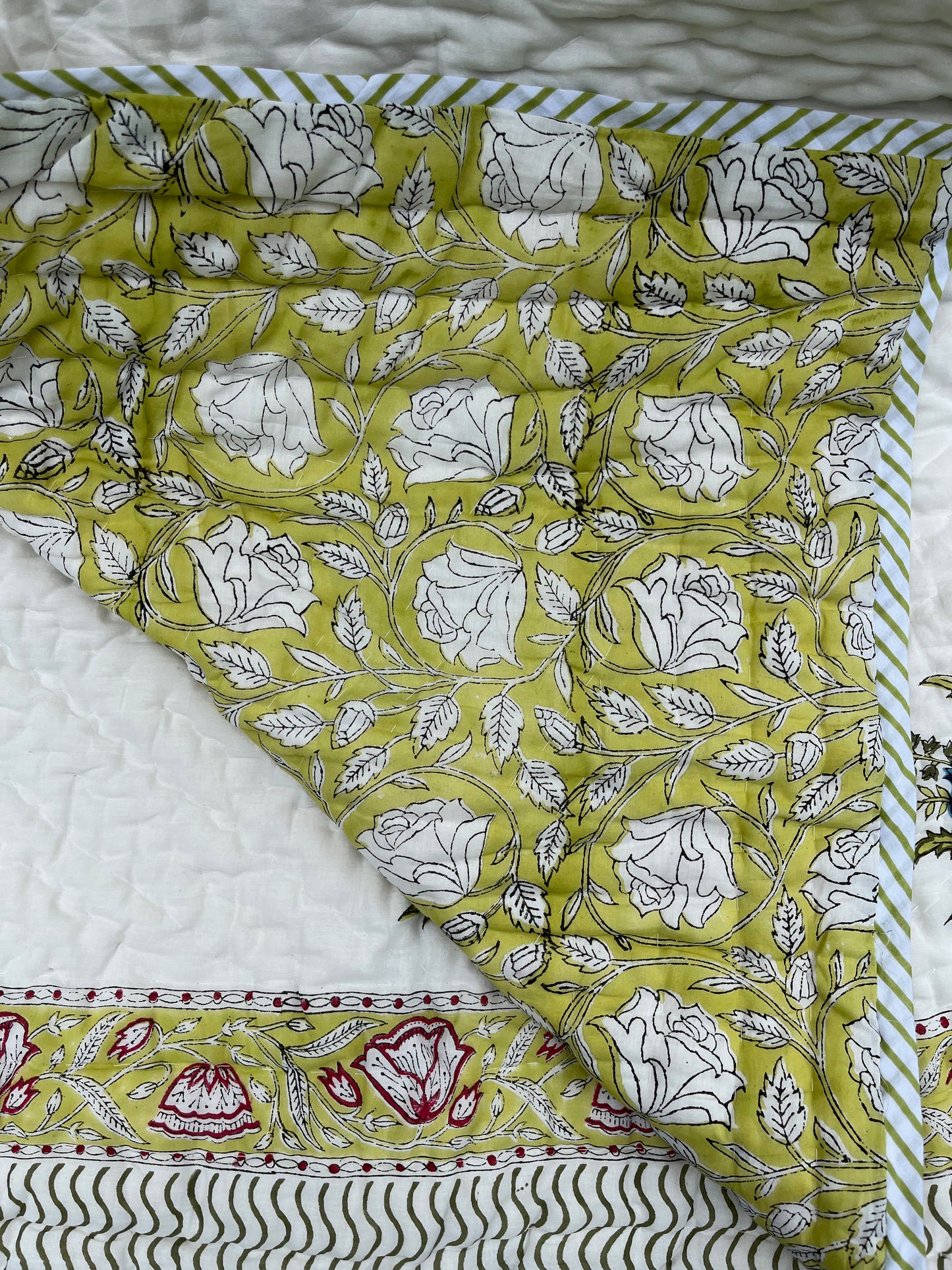 folded reversible hand block printed cotton quilt