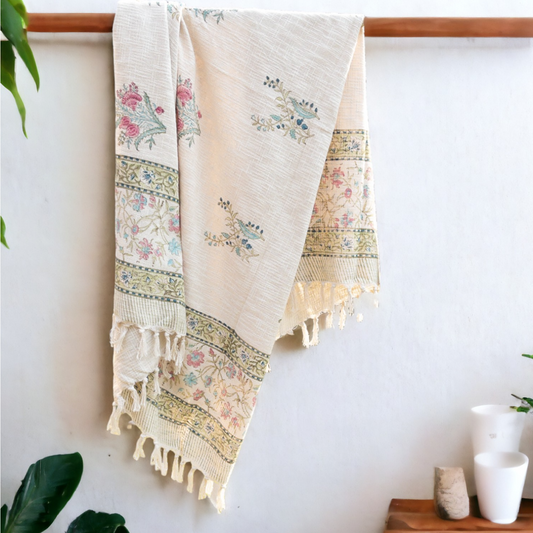a hand block printed throw hanging from a rod